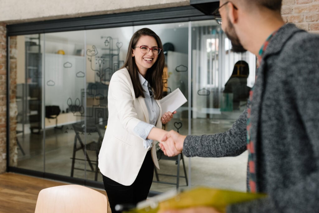 an employer shaking hands with a recruitment consultant